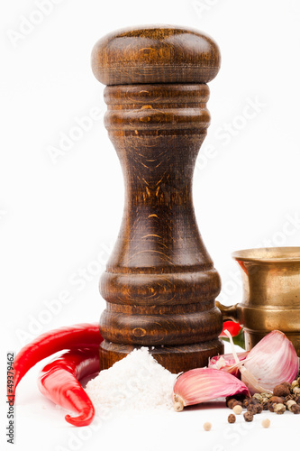 Photo: brass mortar with salt shaker and spices isolated on white brass mortar with salt shaker and spices isolated on white