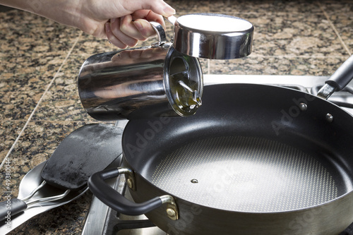 Photo: Adding cooking oil in frying pan Adding cooking oil in frying pan