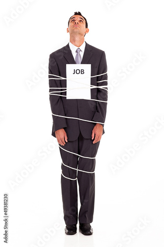 Photo: young man looking for a way out of a boring job young man looking for a way out of a boring job