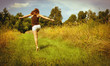 Photo: Back of young woman skipping down nature walk way Back of young woman skipping down nature walk way