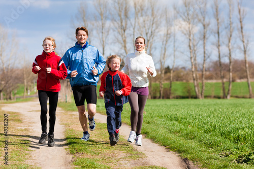 Photo: Family is running outdoors Family is running outdoors