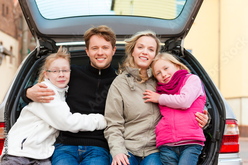 Photo: Family on a car trip sitting in the back Family on a car trip sitting in the back