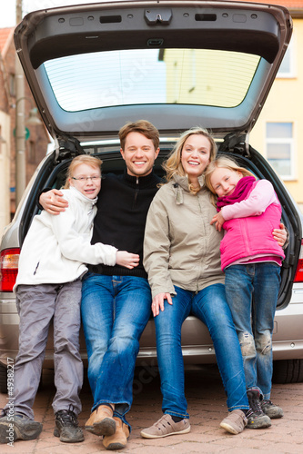 Photo: Family on a car trip sitting in the back Family on a car trip sitting in the back