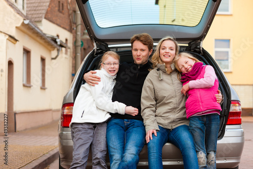 Photo: Family on a car trip sitting in the back Family on a car trip sitting in the back