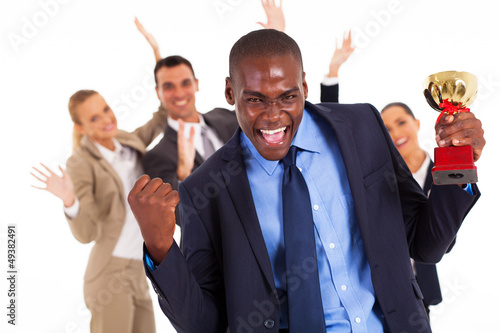 Photo: excited african american businessman winning a trophy excited african american businessman winning a trophy