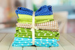Color mottled fabrics on wooden table on room background