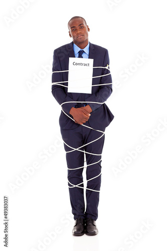 Photo: african american businessman tied with contract african american businessman tied with contract