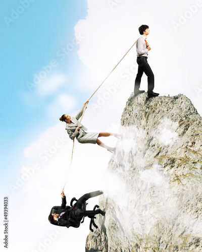 Photo: Three business people pulling rope Three business people pulling rope