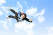 Young businessman flying with parachute on back