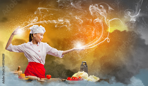 Photo: Asian female cooking with magic Asian female cooking with magic
