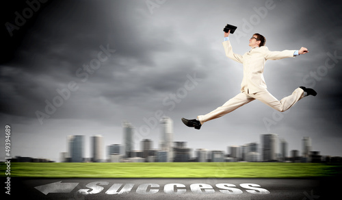 Photo: Businessman running on the road Businessman running on the road