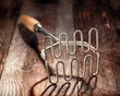Old wood and metal potato masher