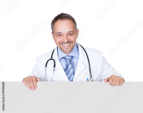 Photo: Portrait Of A Doctor Holding Blank Placard Portrait Of A Doctor Holding Blank Placard