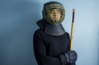 An eskrimador wearing protective helmet and gloves