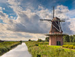 Dutch Windmill besides a Canal