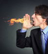 From the mouth of a man a fire erupts.