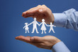 Paper chain family protected in cupped hands