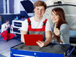 Customer and mechanic looking at a quotation, showing thumbs up