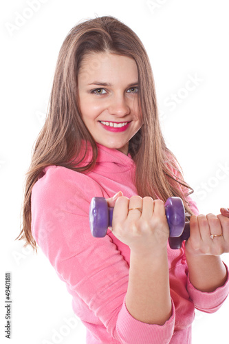 Photo: girl is engaged in fitness with dumbbells girl is engaged in fitness with dumbbells