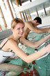 People exercising with aquatic bikes in spa center
