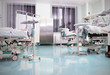 Medical beds with patients in the ward at the hospital.