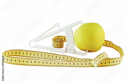 Photo: apple, meter and caliper on a white background apple, meter and caliper on a white background
