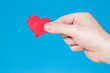 Hand with heart on blue background