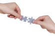 Hands connecting jigsaw puzzle