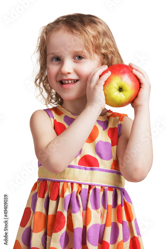 Photo: Happy little girl with an apple in his hand Happy little girl with an apple in his hand