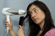 Young woman with hair dryer