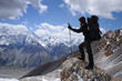 Young woman enjoys spectacular view to high mountains
