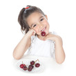 Little girl eating red berries