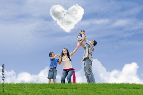 Photo: Family have fun under love clouds Family have fun under love clouds