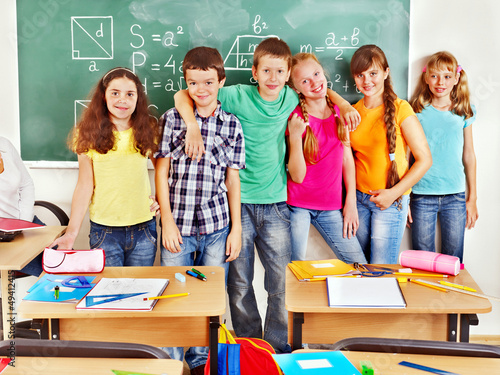 Photo: School child sitting in classroom. School child sitting in classroom.
