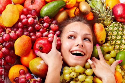 Photo: Girl in group of fruit. Girl in group of fruit.