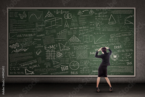 Photo: Thinking teacher in front of blackboard Thinking teacher in front of blackboard