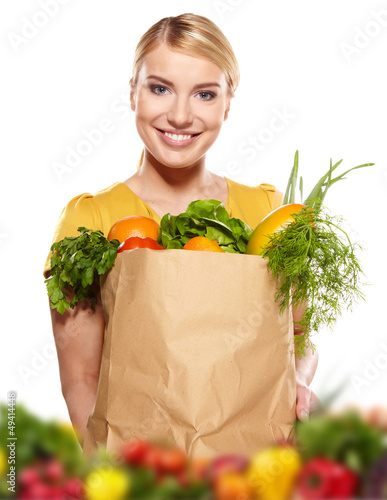 Photo: Young woman with a grocery shopping bag. Isolated on white backg Young woman with a grocery shopping bag. Isolated on white backg