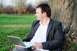 Middle age man with laptop outdoors