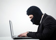 Hacker stealing information from a computer at the desk