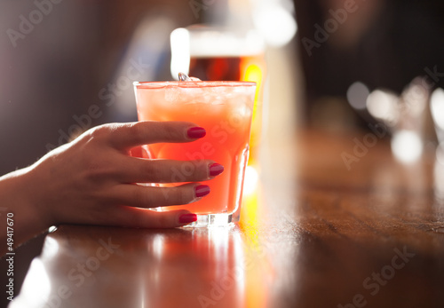 Photo: Woman holding a cocktail Woman holding a cocktail