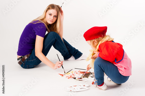 Photo: Pretty young mother and daughter drawing Pretty young mother and daughter drawing