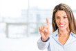 Businesswoman touching a screen