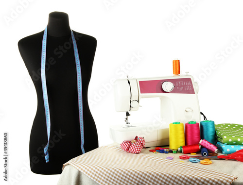 Photo: Sewing machine, dummy and other sewing equipment isolated Sewing machine, dummy and other sewing equipment isolated