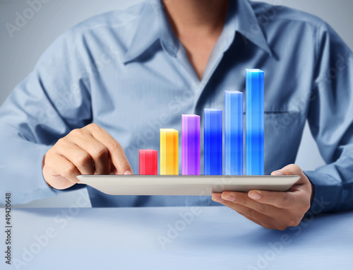 Photo: holding touch screen tablet with graph holding touch screen tablet with graph