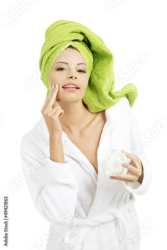 Photo: Attractive fit woman with moisturizer cream Attractive fit woman with moisturizer cream