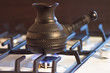 Ceramic pot with coffee on cooking on gas fire