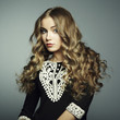 Portrait of beautiful young blonde girl in black dress