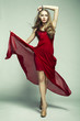 Fashion photo of young magnificent woman in red dress