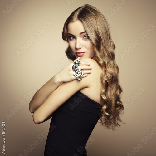 Photo: Portrait of beautiful blonde woman in black dress Portrait of beautiful blonde woman in black dress