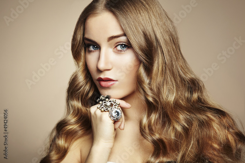 Photo: Portrait of young beautiful woman with jewelry Portrait of young beautiful woman with jewelry